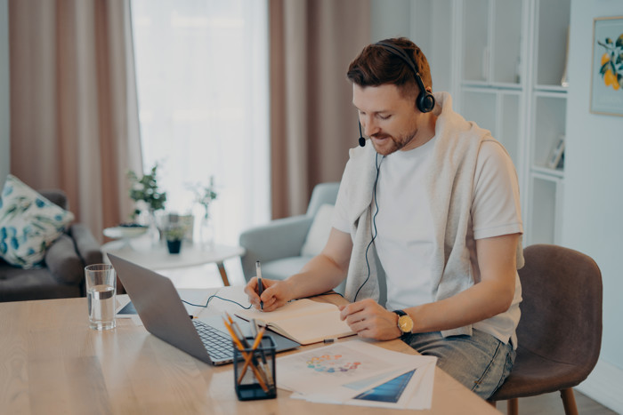 Man Makes Notes While Listening